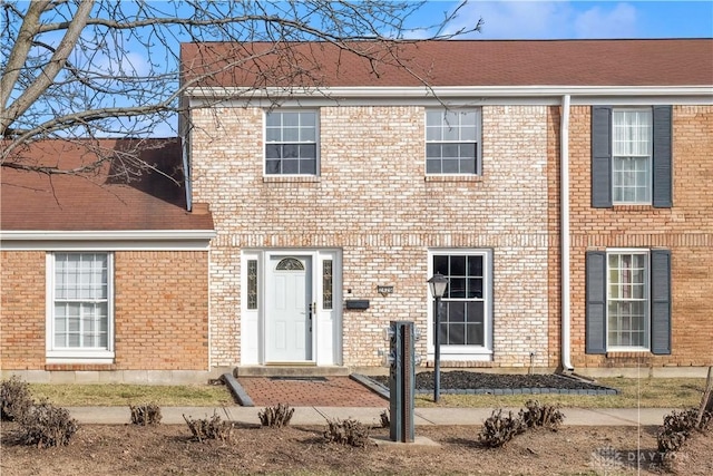 rear view of property with brick siding