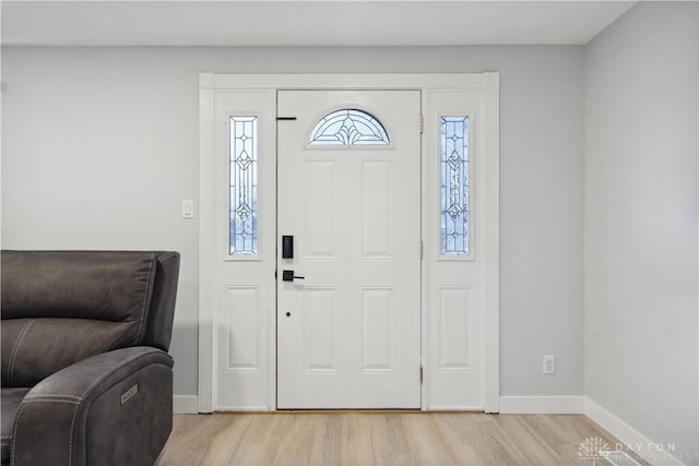 entryway with light wood-style floors and baseboards