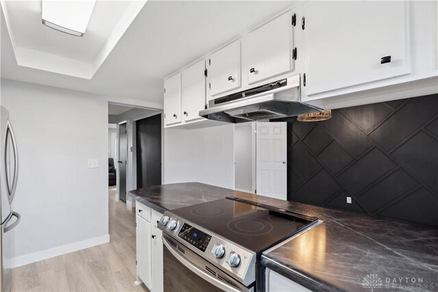 kitchen featuring appliances with stainless steel finishes, dark countertops, white cabinetry, and under cabinet range hood