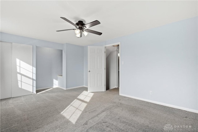 unfurnished bedroom featuring carpet, baseboards, and a ceiling fan