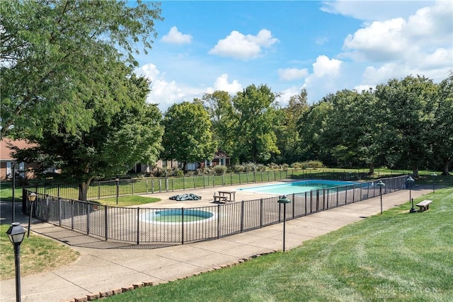 view of pool with a yard, fence, and a fenced in pool