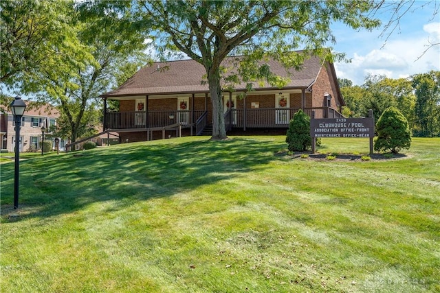 back of house featuring brick siding and a lawn