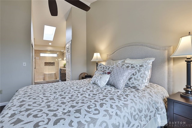 bedroom with ceiling fan, a skylight, and ensuite bath