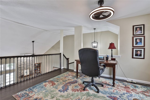 office space with vaulted ceiling, ceiling fan, wood finished floors, and baseboards