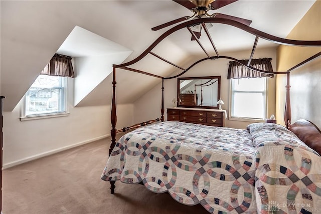 carpeted bedroom with baseboards and vaulted ceiling