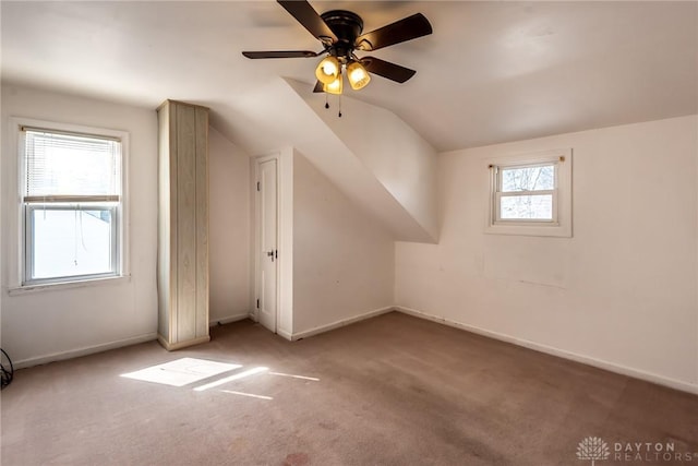 additional living space with carpet, baseboards, and vaulted ceiling