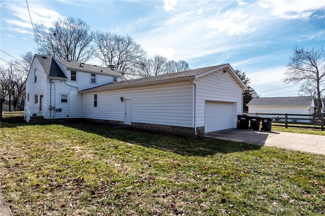 view of home's exterior with a yard, fence, driveway, and a garage