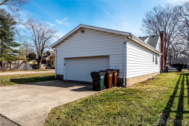 view of home's exterior with concrete driveway, a chimney, an attached garage, a yard, and central air condition unit