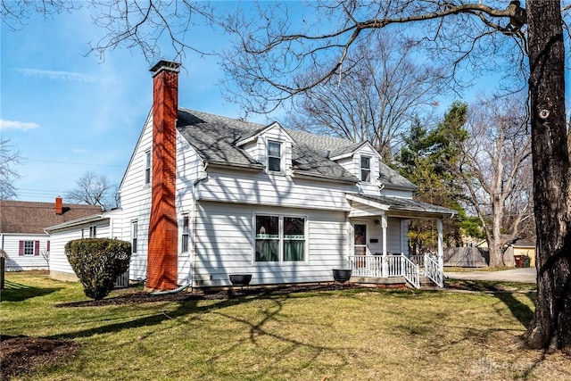 cape cod house featuring a shingled roof, a chimney, and a front yard