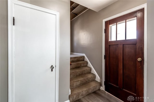 foyer entrance with stairway and wood finished floors