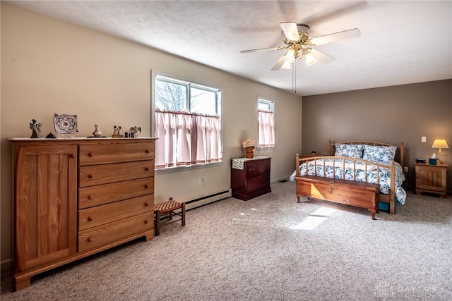 bedroom featuring carpet floors, a textured ceiling, a baseboard heating unit, and a ceiling fan