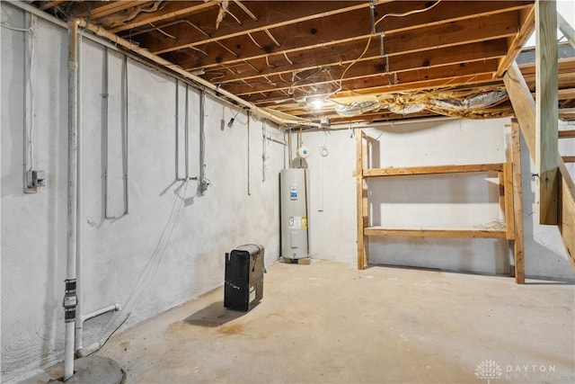 unfinished basement featuring electric water heater