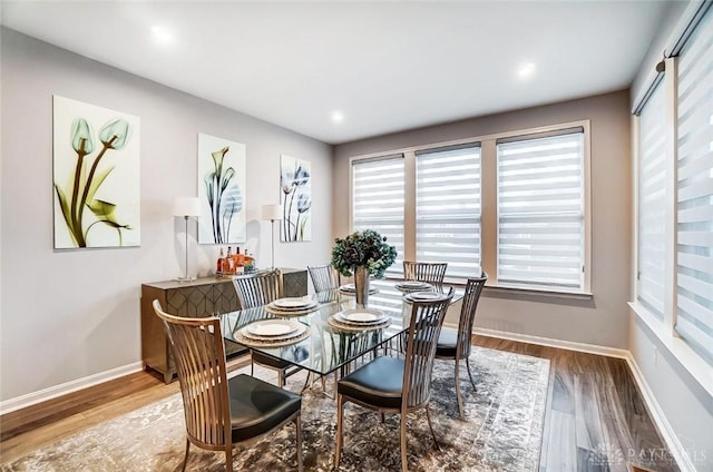 dining space with wood finished floors and baseboards