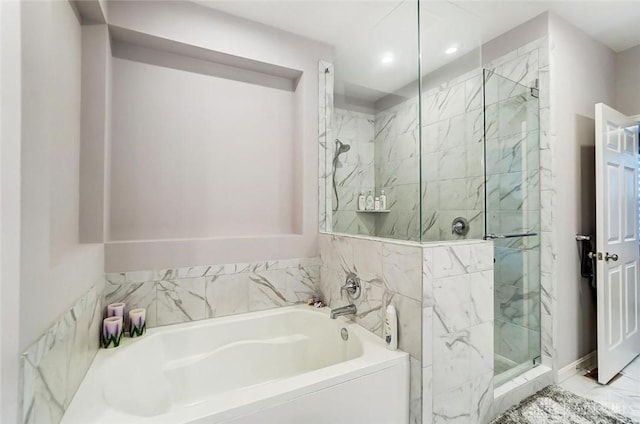 bathroom with a stall shower, marble finish floor, a bath, and recessed lighting