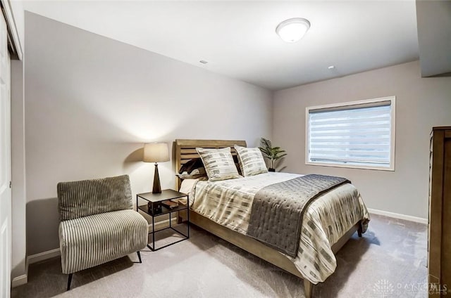 carpeted bedroom featuring baseboards