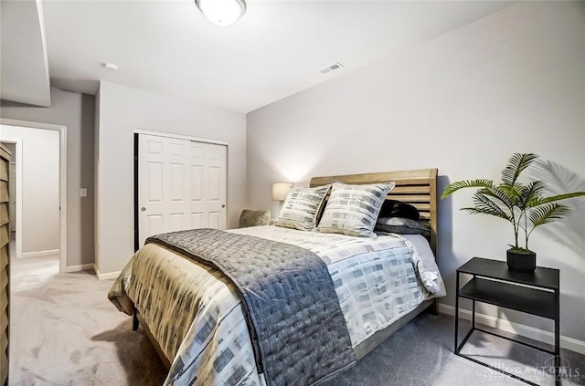 bedroom with carpet floors, a closet, visible vents, and baseboards