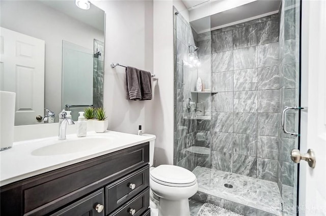 bathroom featuring tiled shower, vanity, and toilet