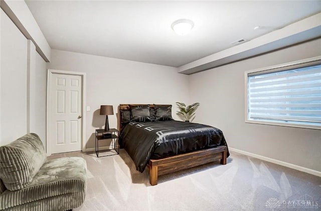 carpeted bedroom featuring baseboards and visible vents