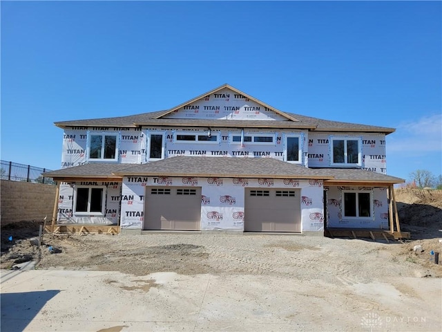 property in mid-construction featuring fence, driveway, and a shingled roof