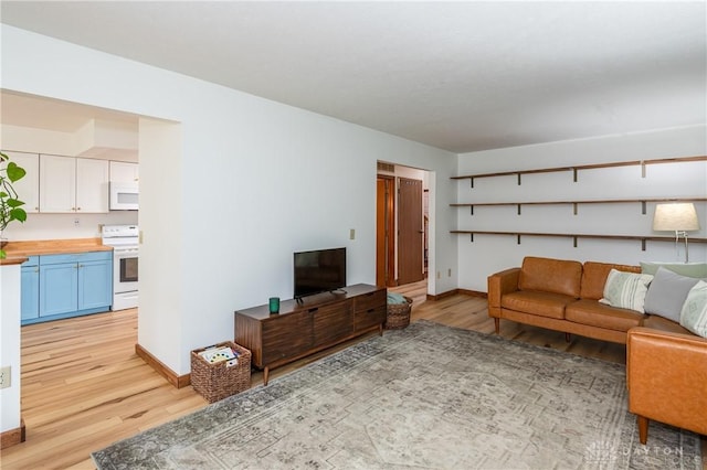 living room featuring baseboards and light wood finished floors