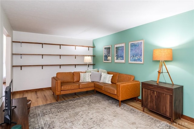 living area featuring wood finished floors and baseboards