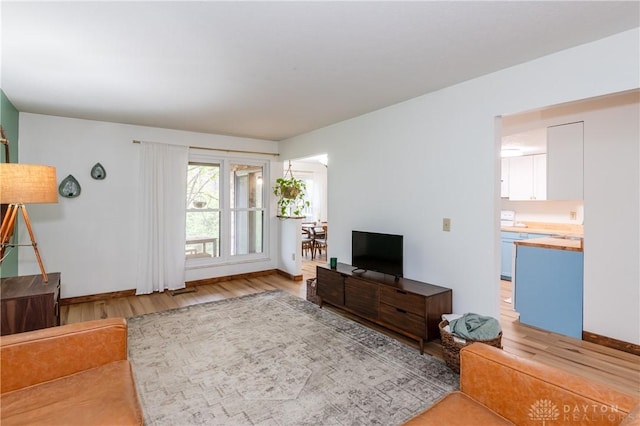 living room with light wood finished floors and baseboards