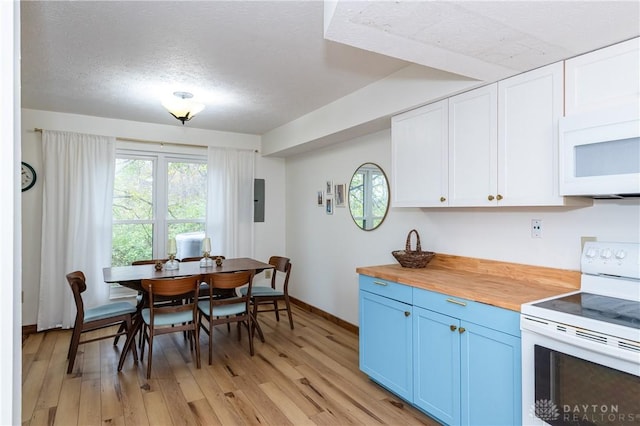 kitchen featuring white appliances, light wood-style floors, blue cabinetry, white cabinetry, and wooden counters