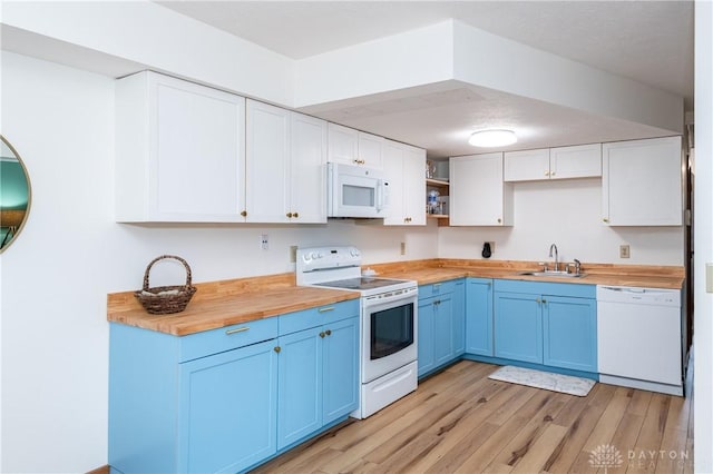 kitchen featuring blue cabinets, white appliances, a sink, wooden counters, and open shelves