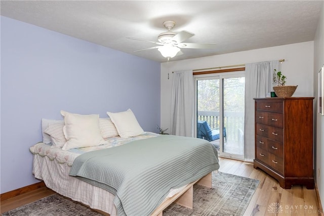 bedroom with access to outside, light wood-type flooring, a ceiling fan, and baseboards