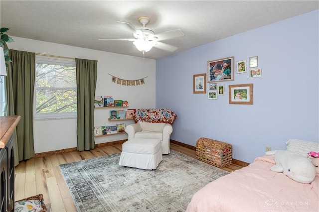 bedroom featuring light wood-style floors, ceiling fan, and baseboards