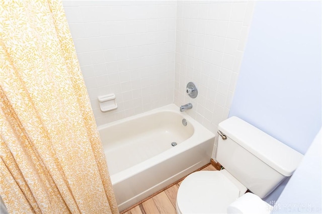 full bath with shower / bath combination with curtain, wood finished floors, and toilet