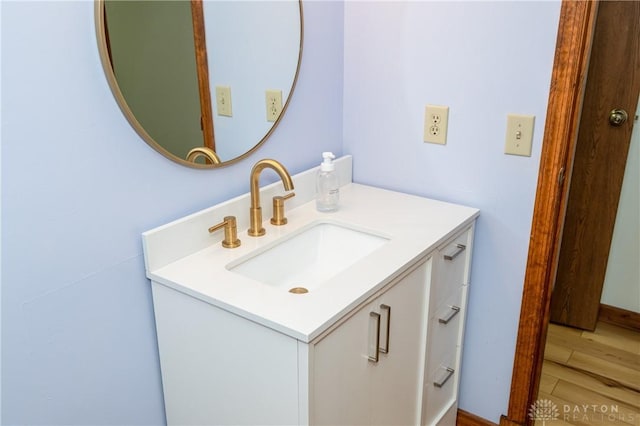 bathroom featuring wood finished floors and vanity