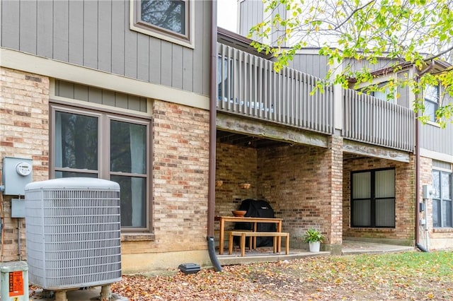 exterior space featuring brick siding and central air condition unit