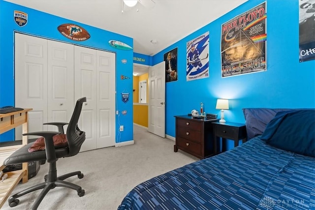 bedroom featuring ceiling fan, baseboards, a closet, and carpet flooring