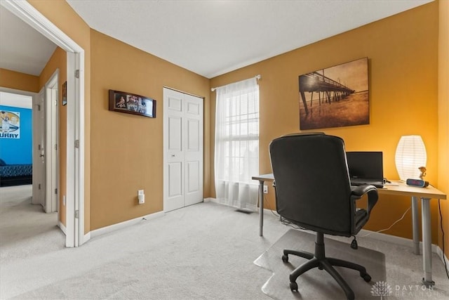 carpeted office space with baseboards