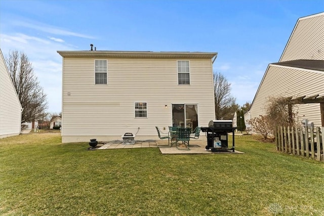 rear view of property featuring a patio area, fence, and a yard