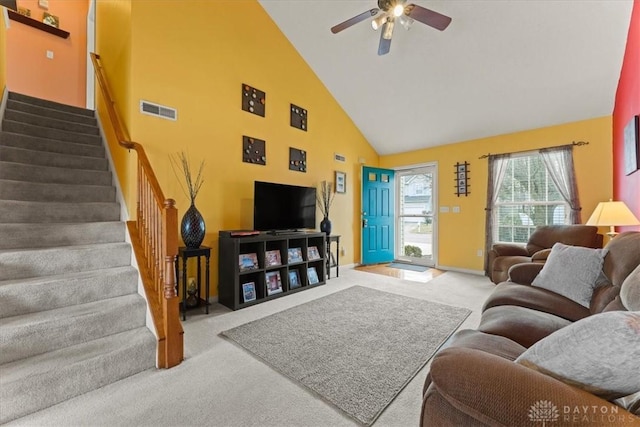 living area with carpet, visible vents, ceiling fan, high vaulted ceiling, and stairs