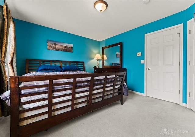 bedroom with carpet and baseboards