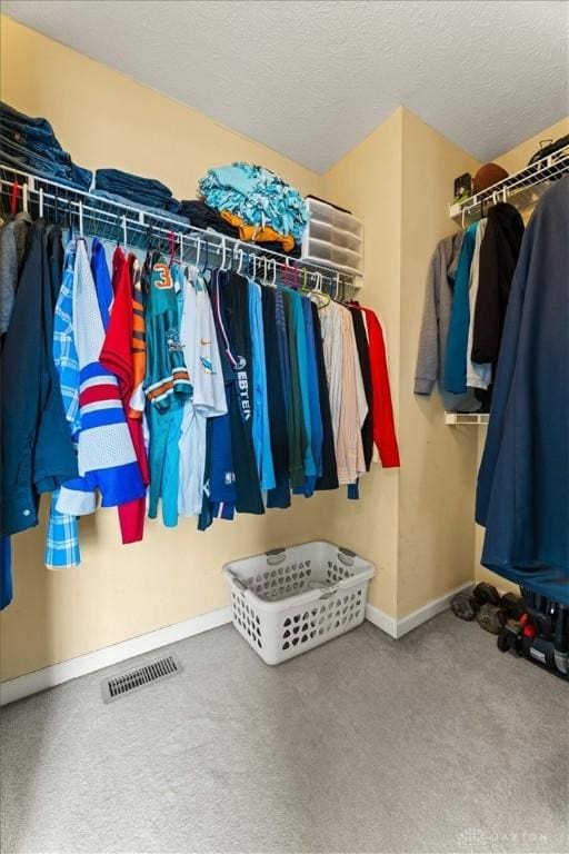 walk in closet featuring visible vents and carpet flooring