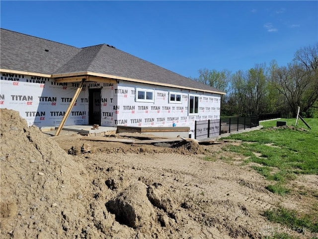 view of side of home with fence