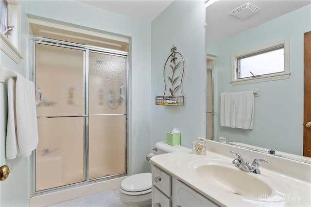 full bath featuring toilet, a stall shower, visible vents, and vanity