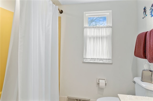 bathroom with visible vents, curtained shower, vanity, and toilet