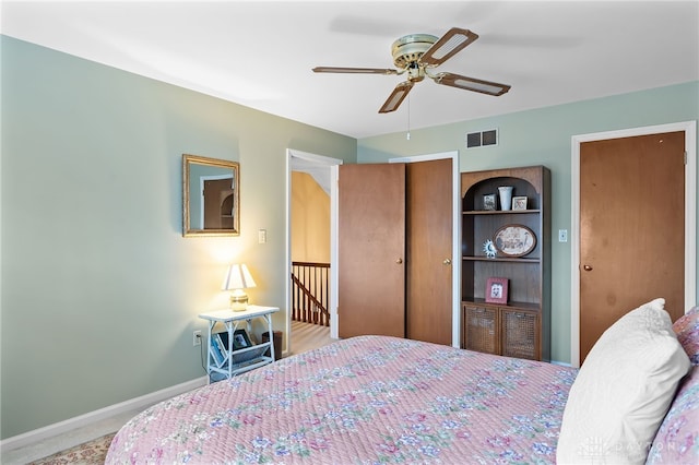 bedroom with carpet floors, a ceiling fan, visible vents, and baseboards