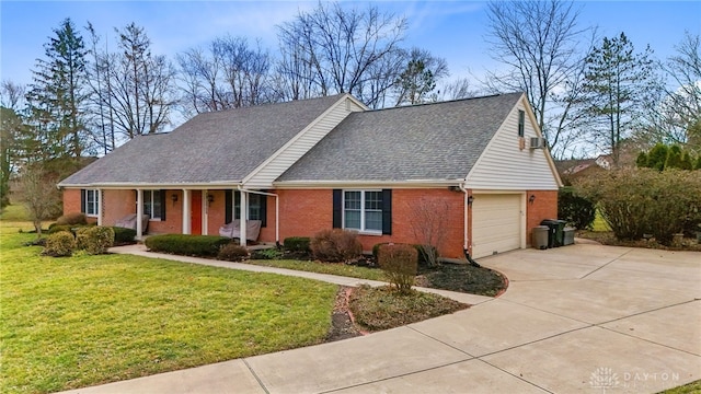 view of front facade with driveway, a shingled roof, a front lawn, a porch, and brick siding