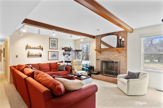 living area featuring visible vents, a brick fireplace, beam ceiling, and light colored carpet