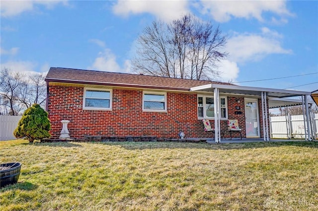 single story home with a front yard, brick siding, and fence