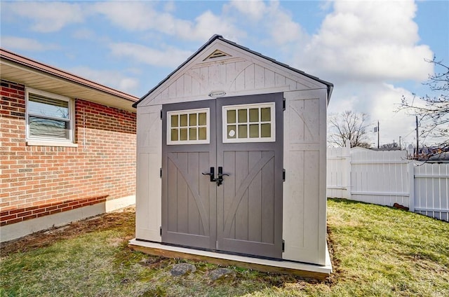 view of shed featuring fence