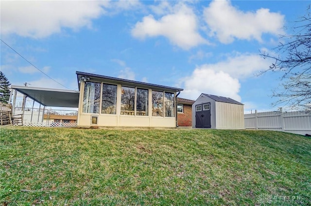 back of property with an outdoor structure, fence, a sunroom, a lawn, and a shed