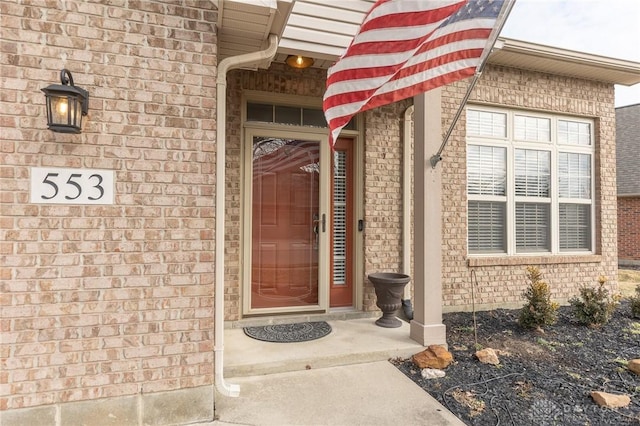 property entrance featuring brick siding