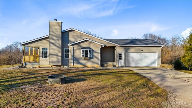 view of front facade with driveway, a chimney, an attached garage, and a front yard